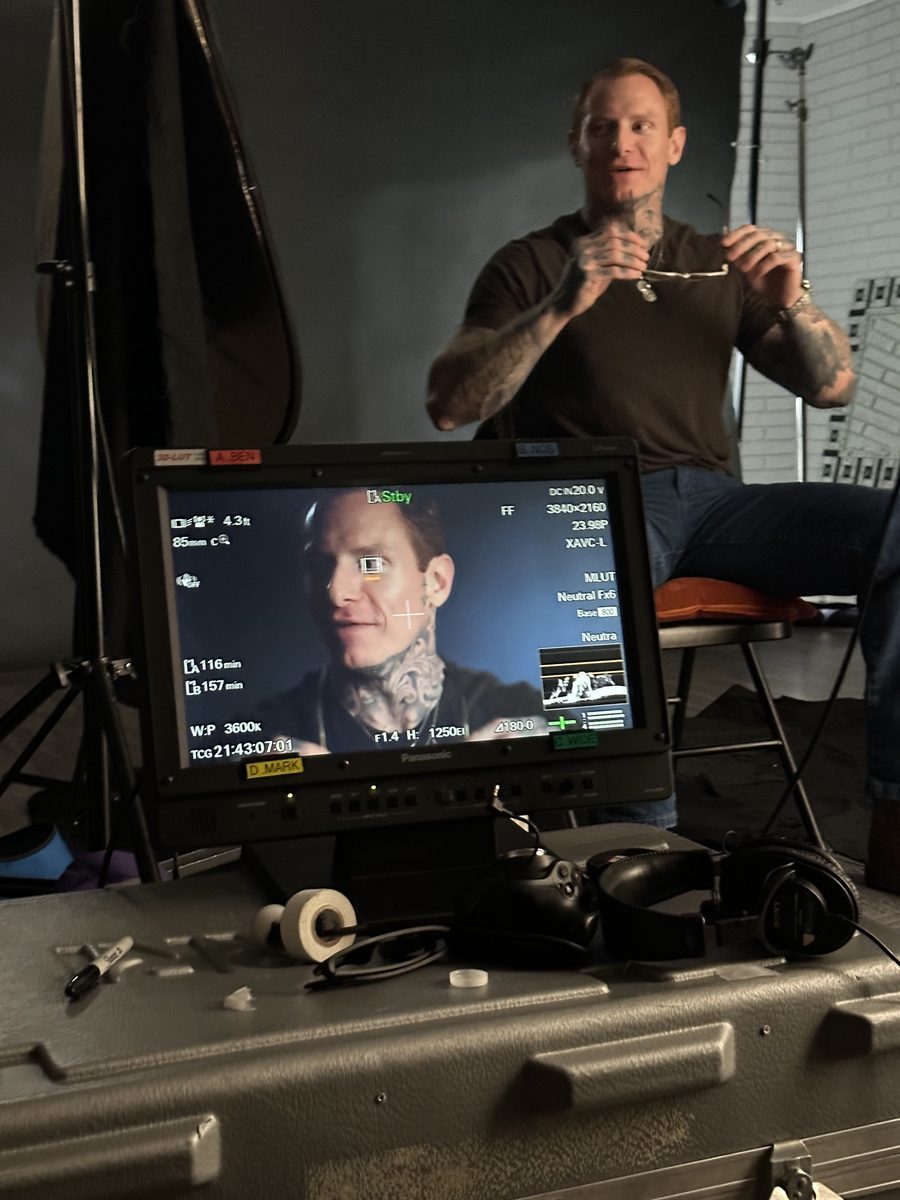 Zach Livingston standing near a production monitor during filming